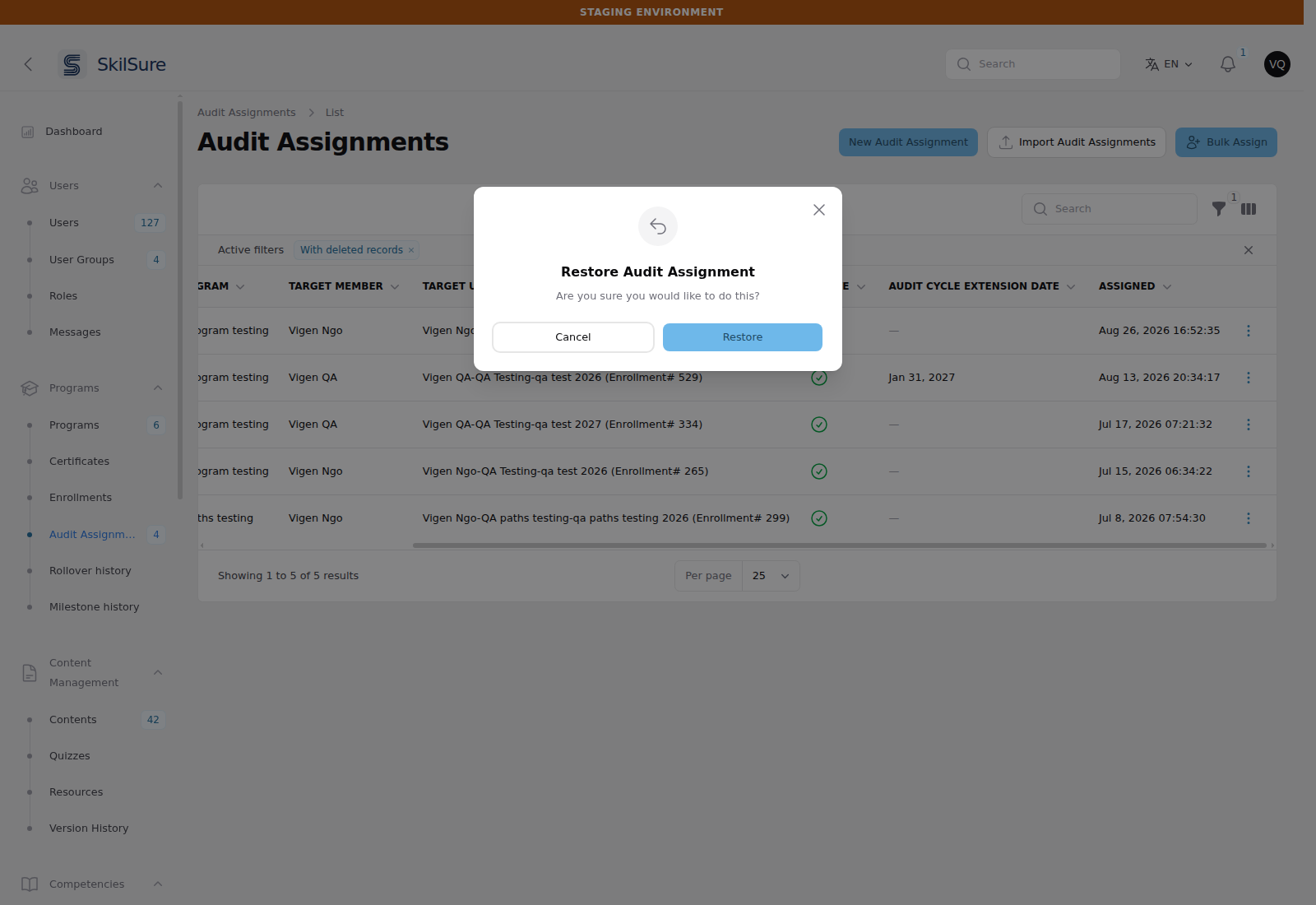 Audit Assignments list with an active "With deleted records" filter chip, showing a deleted assignment whose Active column is a red cross while the others are green ticks, and a Restore Audit Assignment confirmation dialog open over it.